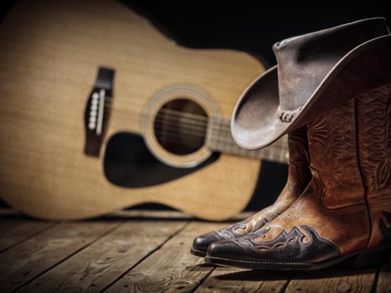 Country music festival live concert with acoustic guitar, cowboy hat and boots