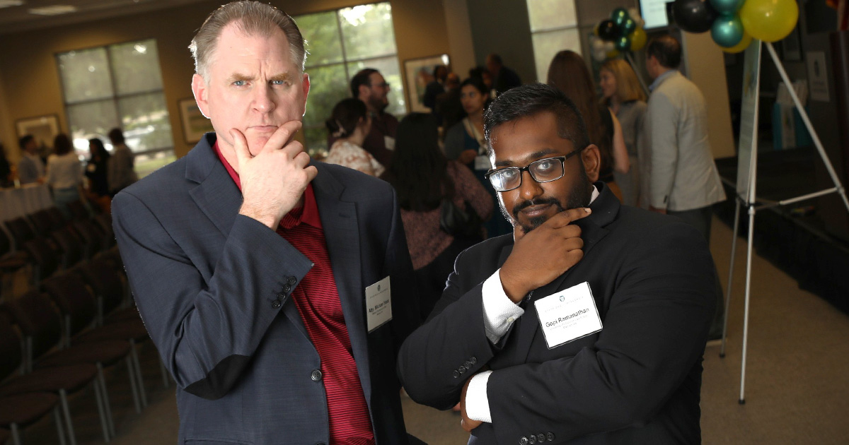two men pose for the photo