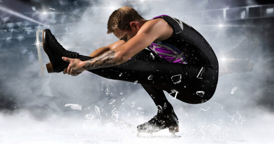 Sit spin. Man figure skating in action on dark background. Sports banne