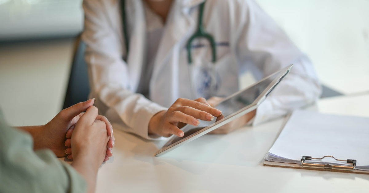 Stock Photo of Doctor Advising Woman Patient